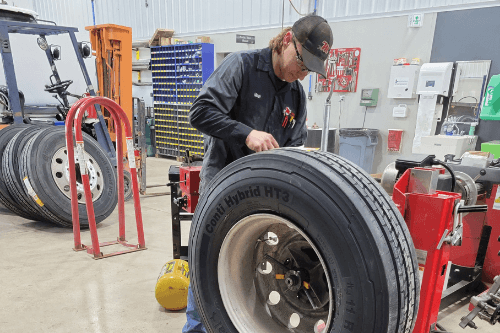 A Mast Service Center technician working on tires