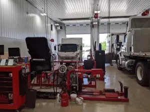 Truck Types, Repair & Maintenance | Mast Service Center Inc. in Etna Green, IN. Image of Mast’s auto repair garage with several kinds of trucks under servicing.