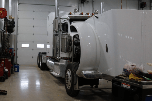 Fleet Maintenance Service near me in Etna Green, IN at Mast Service Center. Image of a white fleet vehicle undergoing repair with its hood open at Mast Service Center.