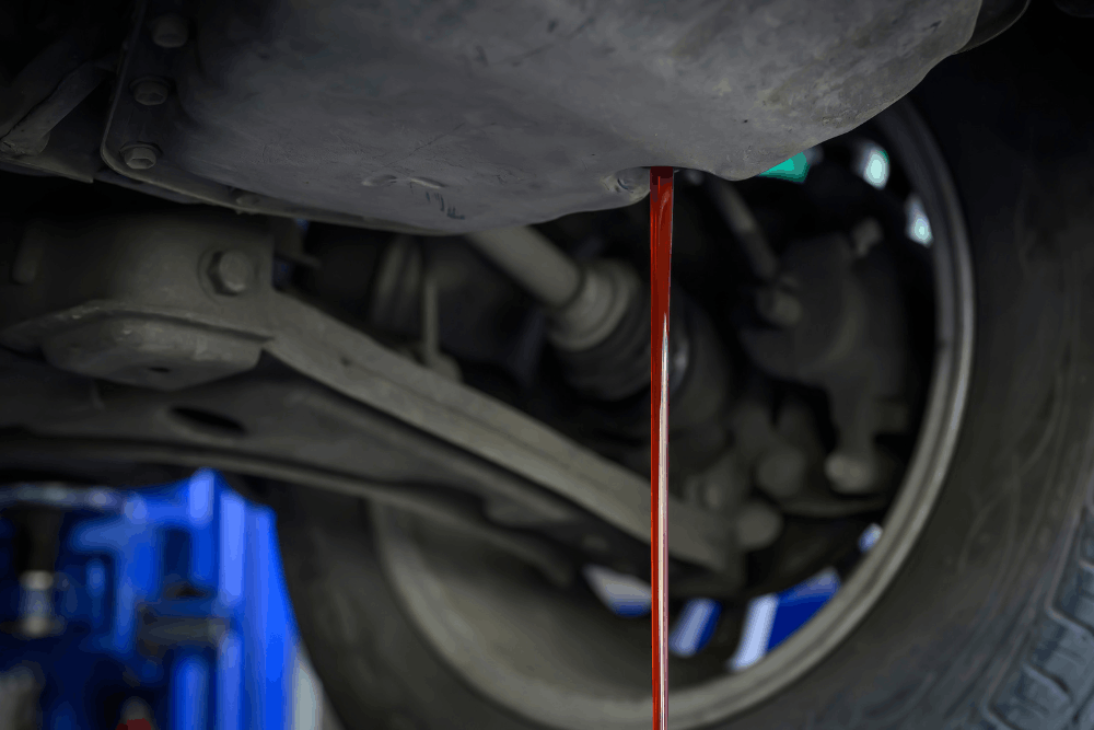 Transmission fluid flush, auto repair in Etna Green, IN by Mast Service Center. Image of transmission fluid draining from a vehicle during routine maintenance, highlighting professional fluid exchange services that protect transmission performance and longevity.
