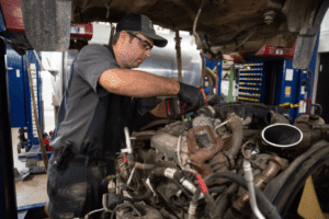Diesel mechanic, diesel repair in Etna, Green at Mast Service Center. Image Eric Troyer working on a truck engine, highlighting skilled diagnostics, precision repairs, and dependable performance for heavy-duty vehicles.